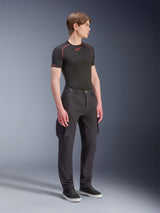 Alpinestars Flex-AST Cargo Pants, Black, Urban motorcycle pants with cargo pockets and elasticated hems, worn by a model with a black short-sleeved base layer and sneakers, modern tapered design