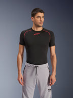 Alpinestars Aeroshell Airflow Pants, Mid Gray, motorcycle pants worn with a black performance base layer, featuring laser-perforated thighs, drawstring waistband, and zippered pockets, sporty urban riding style.