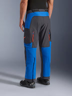 Alpinestars Maxdura Dual Pants, Royal Blue and Deep Gray, rear view showing zippered pockets and ventilation zones, over-boot design worn with black Alpinestars boots, durable adventure and dual-sport riding gear