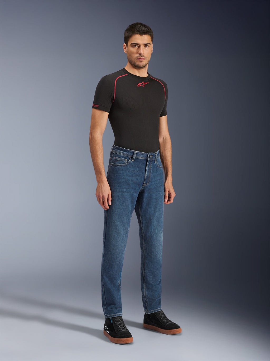 Alpinestars Flex-AST 5 Denim Pants - Short, Indigo Washed, urban motorcycle jeans with a tapered fit, worn by a male model with a black tight-fitting shirt and black sneakers, classic denim style for road-to-street transitions