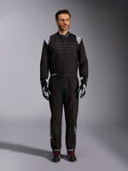 Alpinestars KMX-9 V3 Suit, Black and White Karting Suit, full-length view on a model, featuring white shoulder logos and accents, styled with black and white racing gloves and black shoes with red laces, athletic-regular fit for professional karting gear.