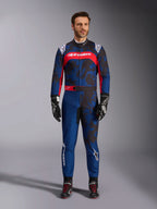 Alpinestars KMX-9 V3 Graphic 5 Suit, Karting Suit in Navy and Red, featuring an abstract camo-style graphic pattern, worn by a model with black racing gloves and shoes, athletic design with prominent Alpinestars branding on the chest and legs.