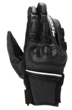 Alpinestars Phenom Leather Gloves, luvas de motociclismo pretas e brancas de cano curto, proteção rígida nos nós dos dedos, detalhes em couro perfurado, logótipo Alpinestars branco no dedo indicador e risca branca no pulso