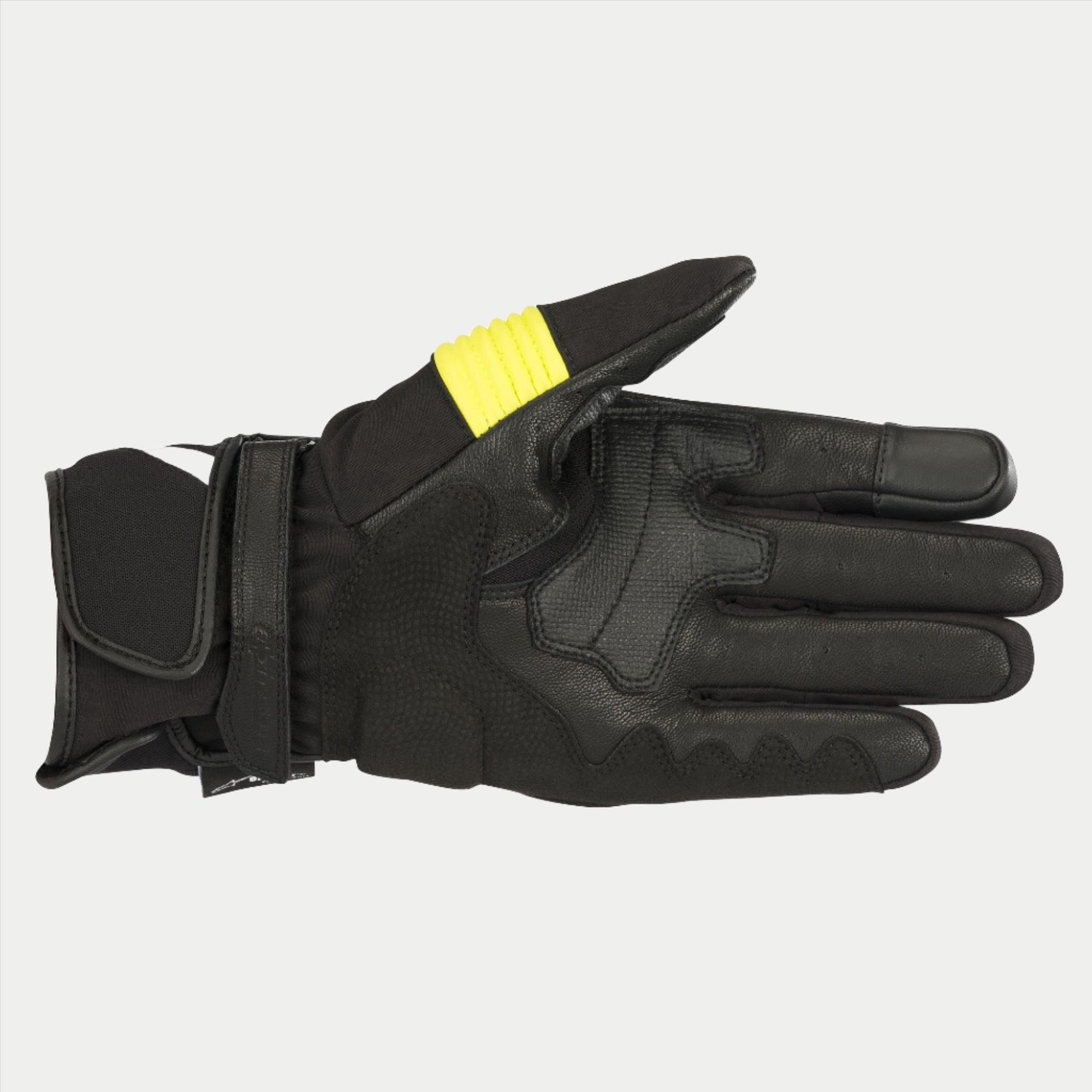 Luvas Alpinestars T-SP W Drystar®, pretas e amarelo fluorescente, vista da palma exibindo construção em pele de cabra com detalhes em amarelo fluorescente no polegar, pontas dos dedos compatíveis com ecrã tátil e fecho de pulso duplo com gancho e laço.