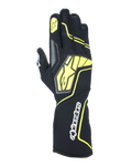 Luvas Alpinestars Tech-1 KX V4, luvas de karting, cinzento, preto e amarelo fluorescente, vista do dorso com construção em malha respirável, logótipo Alpinestars grande em amarelo, marca nominativa branca no pulso, estrela amarela no dedo indicador, design desportivo moderno
