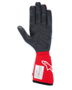 Alpinestars Tech-1 Race V4 Gloves, Auto Racing Gloves, White and Red, palm view featuring textured black silicone grip patterns and an FIA 8856-2018 certification label on the red gauntlet cuff, professional motorsport gear