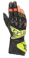 Luvas Alpinestars GP Tech V2, luvas de motociclismo para corrida, pretas com detalhes em amarelo fluorescente e vermelho, com proteção rígida nos nós dos dedos, punho em pele perfurada com marca DFS e painéis elásticos em acordeão para flexibilidade ideal.