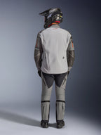 Alpinestars Nazca 3L GORE-TEX PRO Jacket, Adventure Motorcycle Jacket, Dark Gray and Mid Gray, rear view of rider wearing complete gear, worn with matching pants and black adventure helmet, featuring a red logo on the back and Superfabric reinforcements on the elbows, durable textile design for adventure touring.