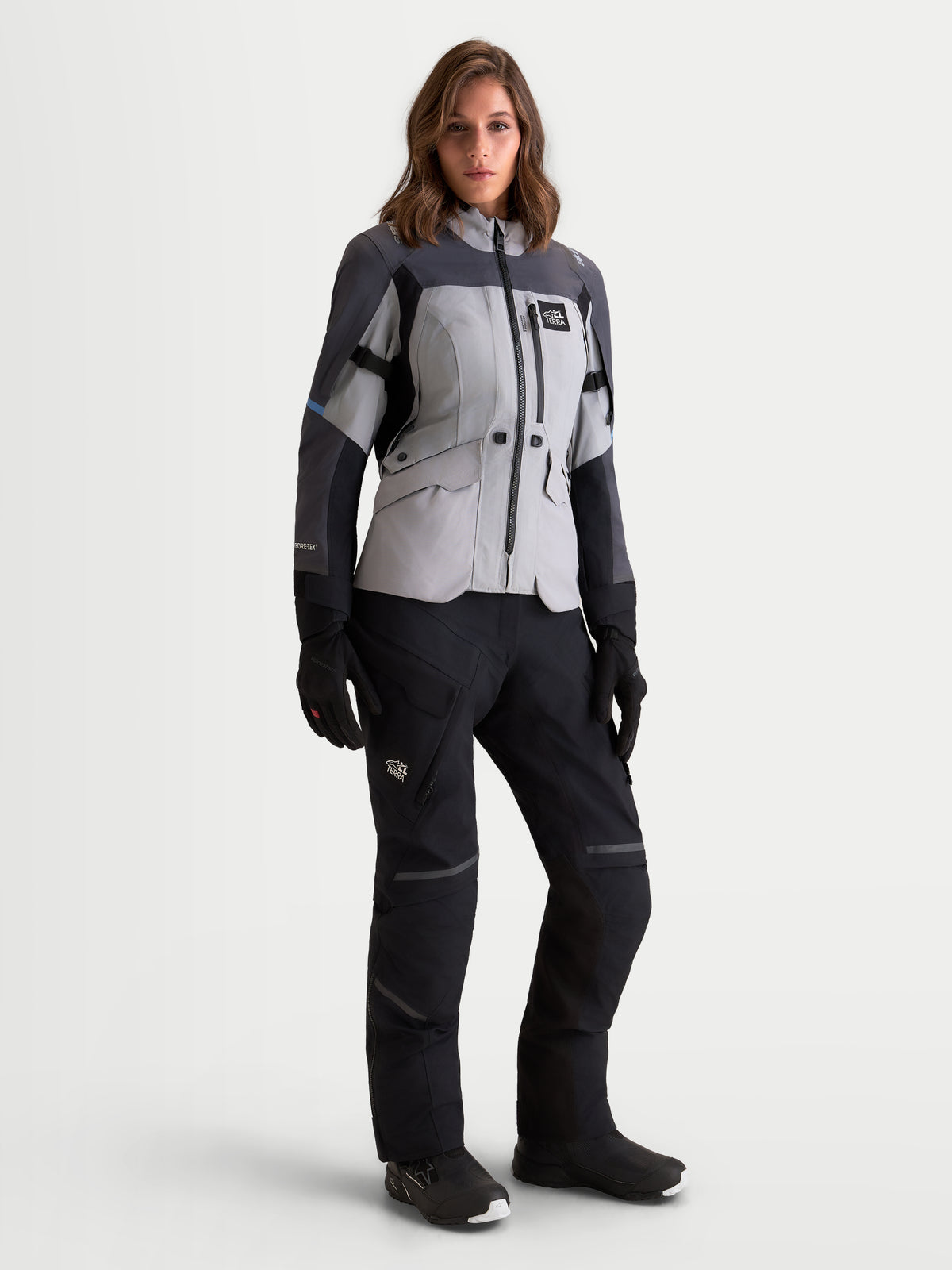 Alpinestars Stella St-7 V2 2L Gore-Tex Jacket, women's adventure touring motorcycle jacket in mid gray, deep gray, and black, full front view on a model wearing matching pants, boots, and gloves, waterproof textile construction.
