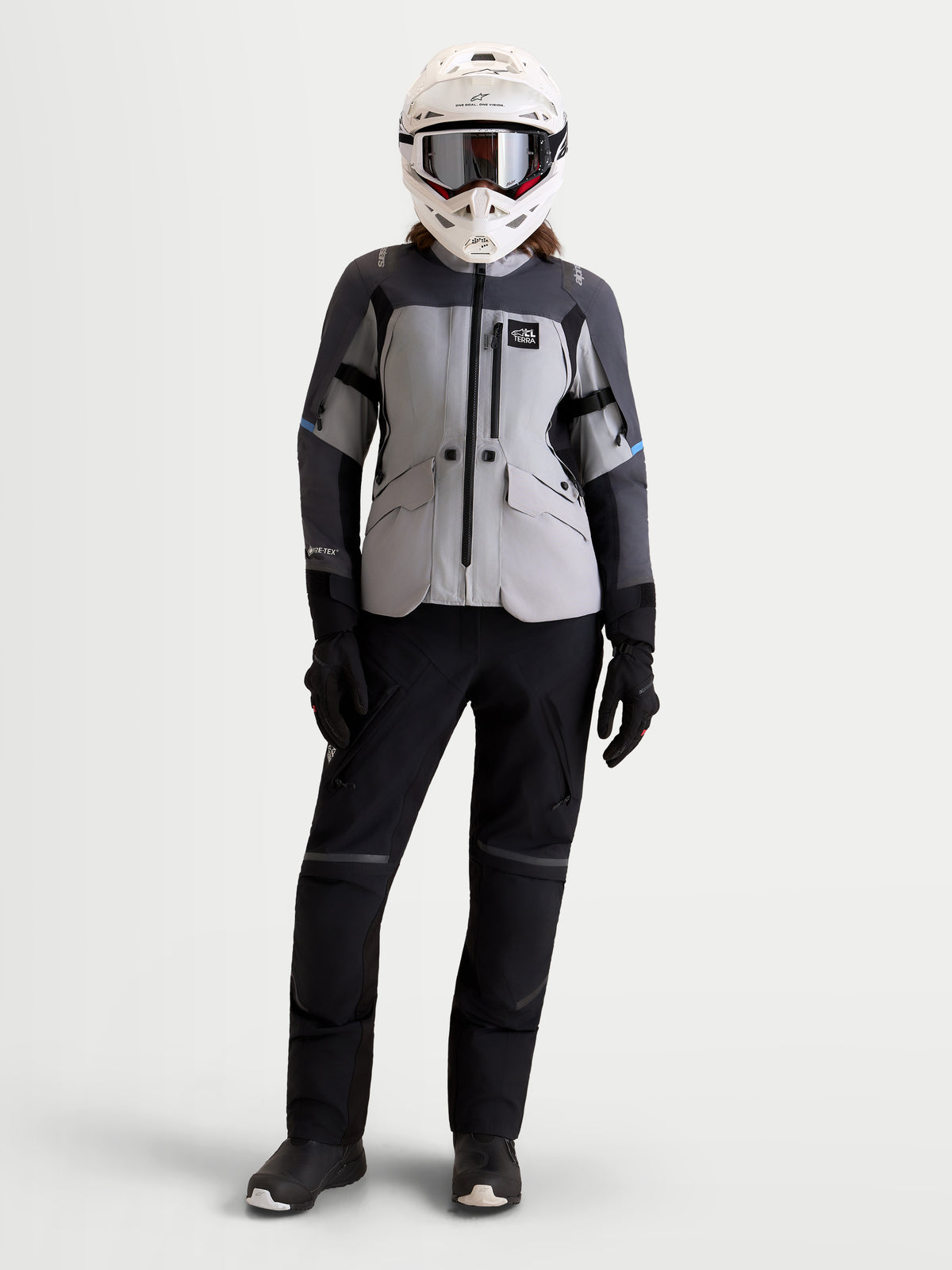Alpinestars Stella ST-7 V2 2L Gore-Tex Jacket, women's adventure touring motorcycle jacket in mid gray, deep gray, and black, front full-body view worn by a model with a matching helmet and pants.