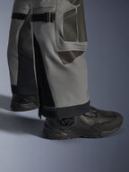 Alpinestars Nazca 3L GORE-TEX PRO Pants, Adventure Motorcycle Pants, Dark Gray and Black, close-up of lower legs featuring calf volume adjusters and Superfabric reinforcements, worn with black Alpinestars boots, durable textile for extreme adventure riding