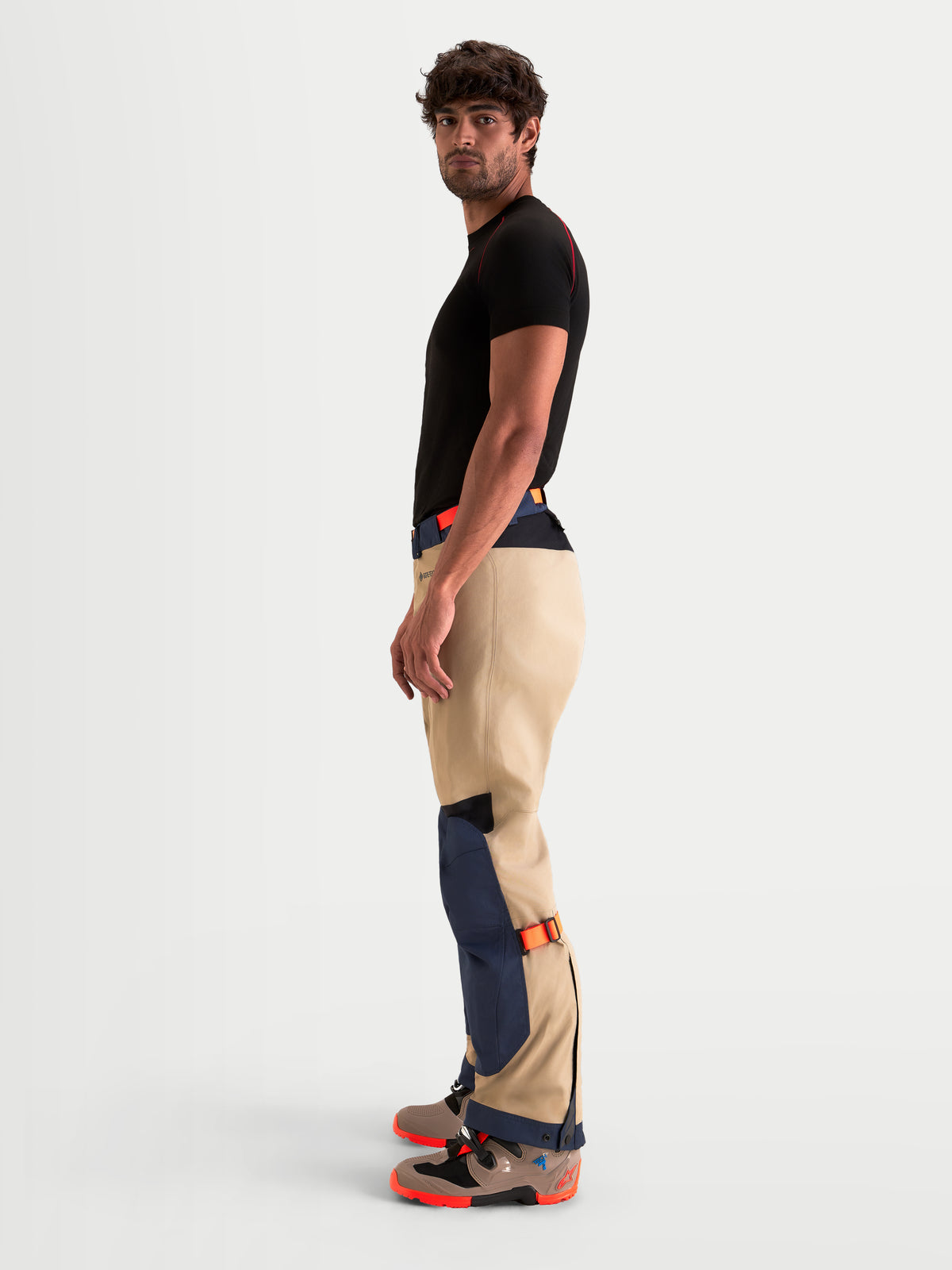 Alpinestars Arenis Gore-Tex Pants, men's adventure touring motorcycle pants in night navy and aluminum, side profile view worn by a model