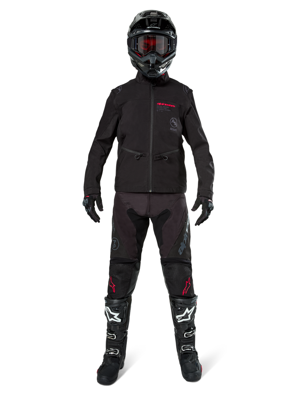 Motocross rider wearing the Alpinestars Lite-Dura Softshell Jacket in Black with red logo details, styled with matching black off-road pants, black helmet, and white and black boots, complete professional enduro racing gear.