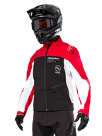 Alpinestars Lite-Dura Softshell Jacket, Motorcycle Jacket, Black, Bright Red, and White, worn by a rider with a black motocross helmet, red goggles, and gloves, featuring bold branding on the chest, designed for off-road and enduro riding