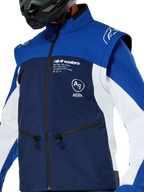 Alpinestars Lite-Dura Softshell Jacket, Motocross and Enduro Jacket, Navy Bright Blue and White, featuring white Alpinestars branding on the chest and zippered pockets, worn with a black helmet, durable softshell construction with detachable sleeves for off-road riding.