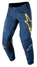 Alpinestars Techstar Phantom Pants, calças de motocross, azul escuro com detalhes em amarelo e branco, painéis de joelho em pele preta, logótipo de estrela amarela grande na coxa, marca ASTARS em branco, tecido rip-stop elástico durável para corridas todo-o-terreno