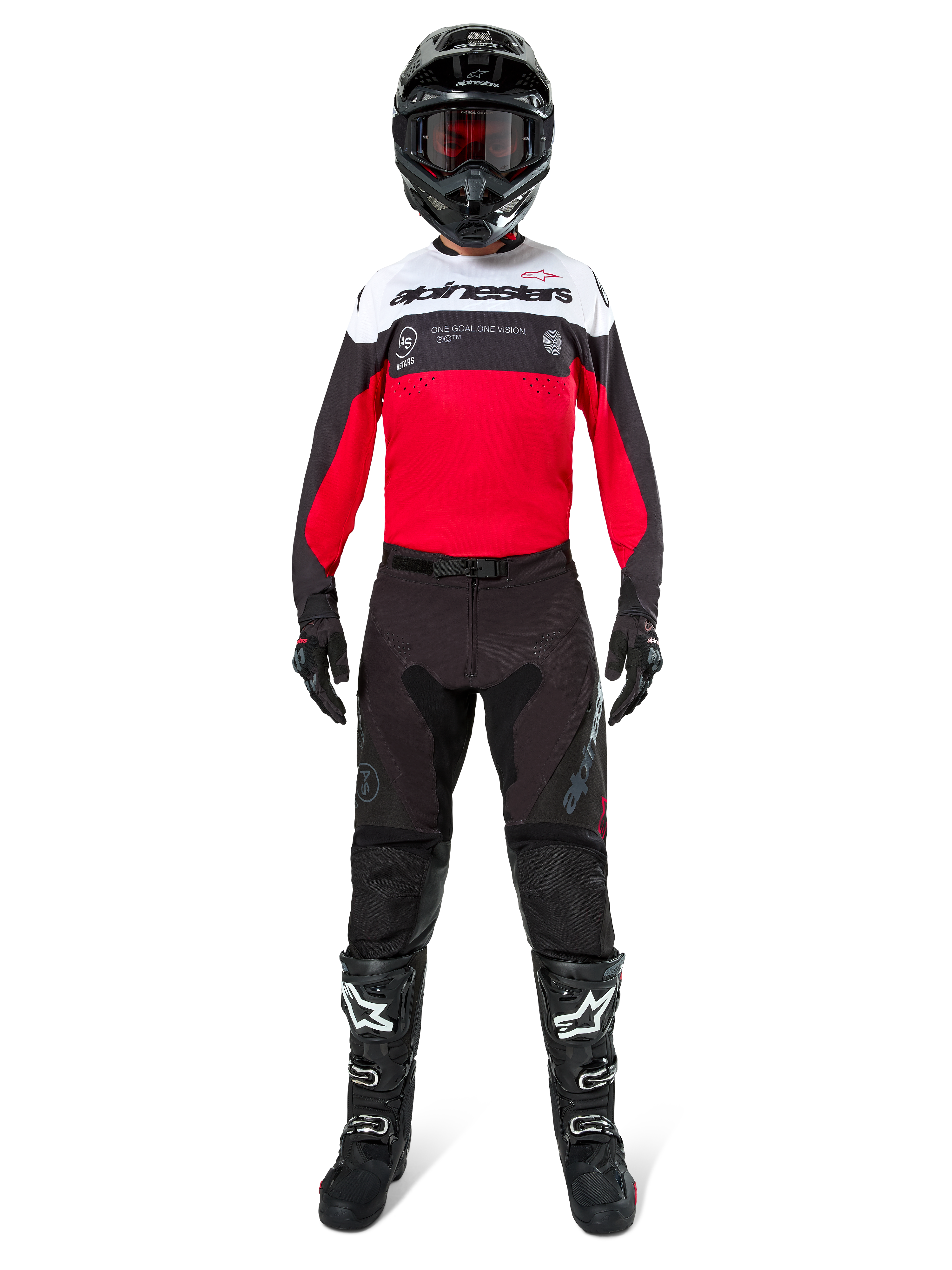 Motocross rider wearing Alpinestars Pro-Dura Pants in Black and Magnet, paired with a red, white, and black jersey, black helmet, and black boots, full off-road racing gear kit, durable and lightweight design for enduro riding