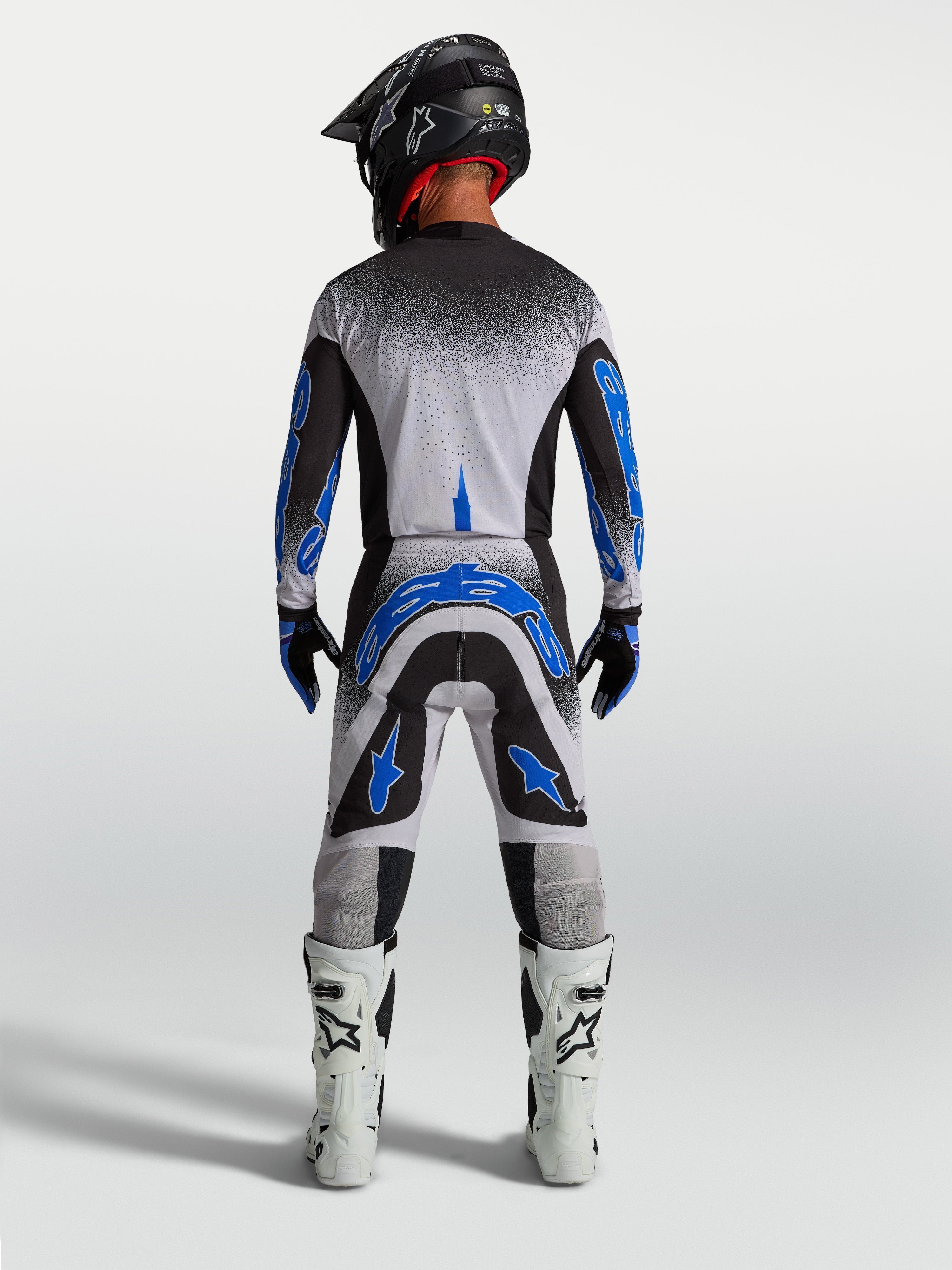 Alpinestars Supertech Hiten AFD, calças de motocross para homem, azuis e brancas, vista traseira com ajuste atlético.
