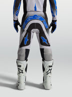 Calças Alpinestars Supertech Hiten AFD para motocross, pretas e azuis, vista traseira com ajuste atlético para off-road