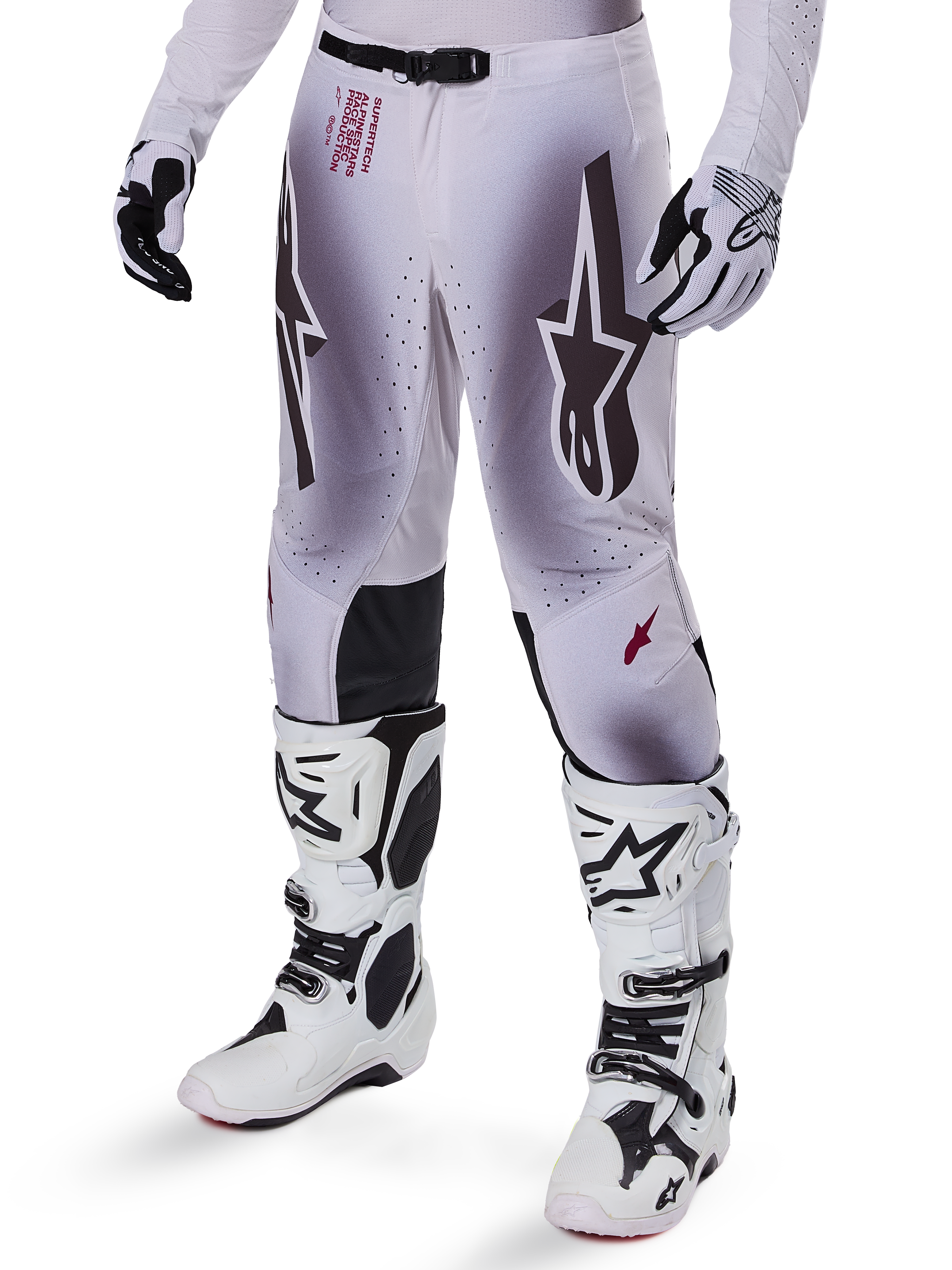 Alpinestars 2025 Supertech Maker Pants, Motocross Racing Pants, Silver and Black, featuring large star logos and red lettering, shown with matching white boots and gloves