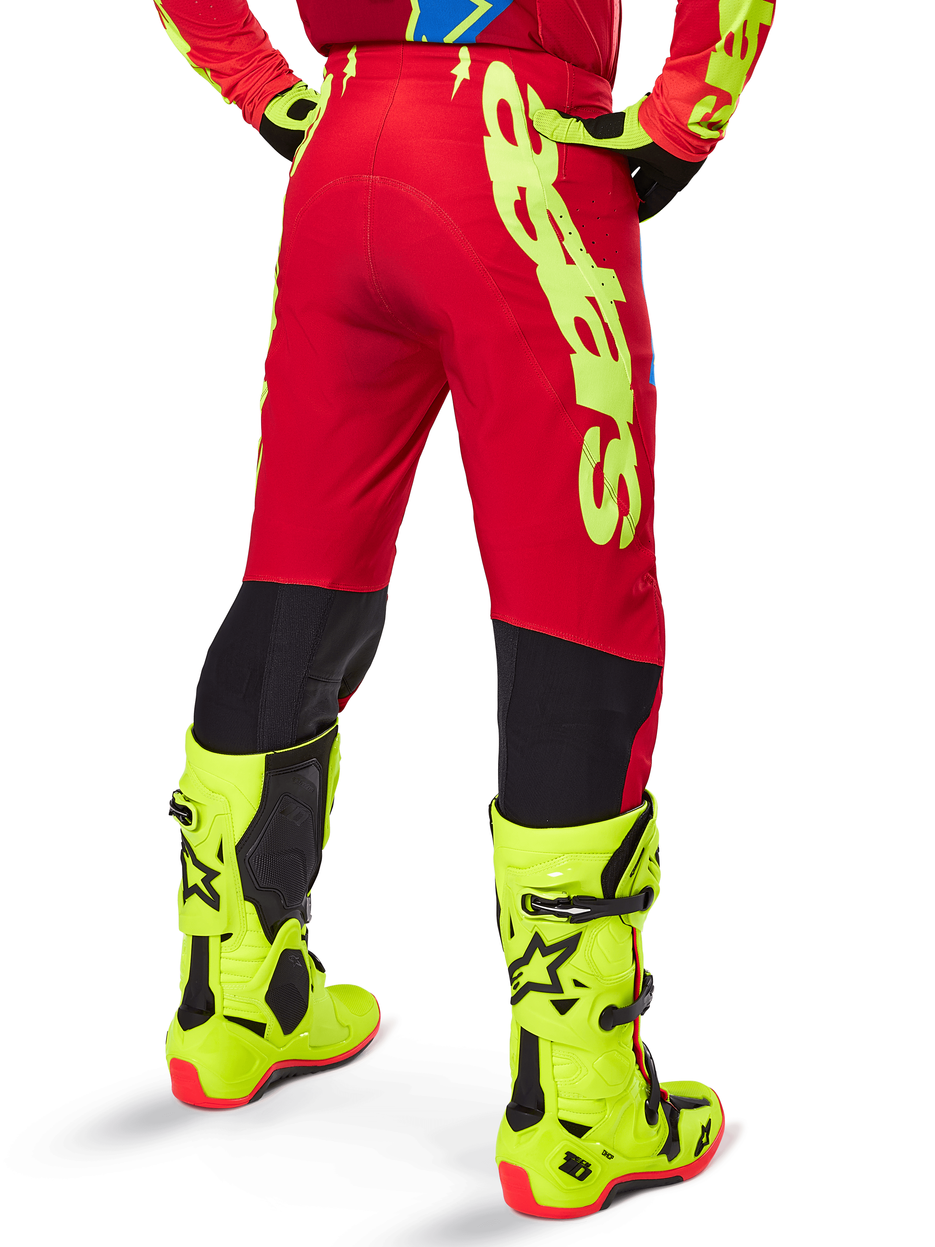 Alpinestars 2025 Supertech Maker Pants, Motocross Pants, Bright Red and Yellow Fluo, rear view, featuring bold yellow branding, black panels behind the knees, worn with matching fluo yellow boots, designed for pro-level off-road performance.