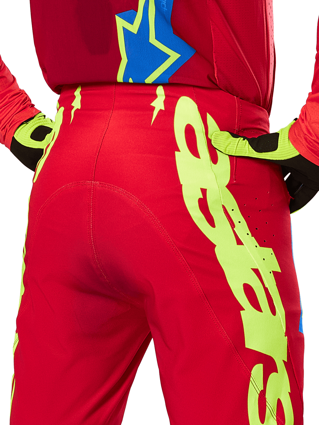 Alpinestars 2025 Supertech Maker Pants, Motocross Pants, Bright Red and Yellow Fluo, rear view featuring large yellow graphics on the legs and matching fluo yellow and black gloves, professional off-road racing gear