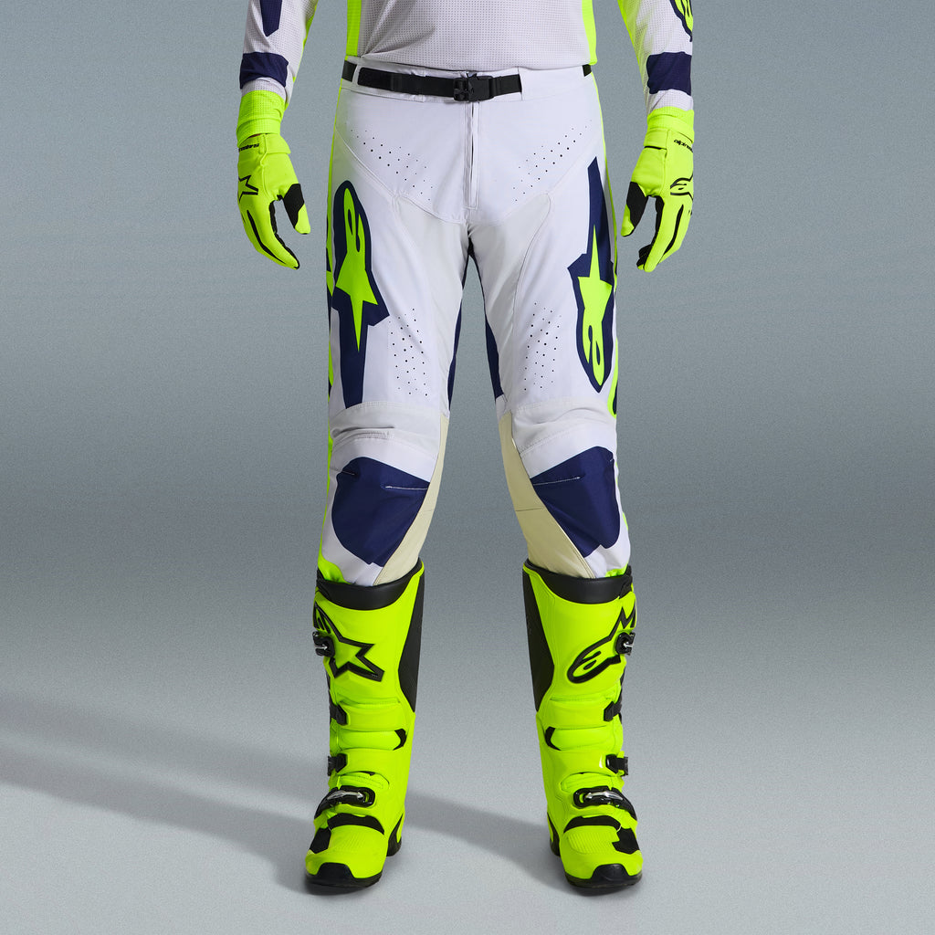 Alpinestars 2026 Racer Air Riway Gear Set, Motocross Pants in White and Navy Blue with Neon Yellow accents, paired with matching neon yellow gloves and boots, featuring ergonomic design and ventilated panels for off-road racing.