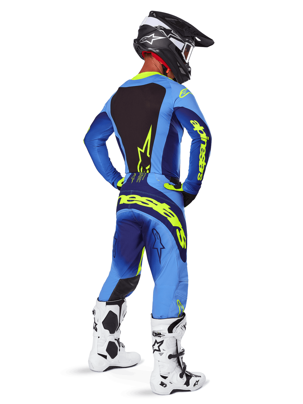Alpinestars 2025 Techstar Melt Pants, equipamento de motocross, Amarelo Fluo Azul, vista traseira de piloto com camisola azul a condizer e marca amarela grande, botas brancas e pretas e capacete preto, conjunto de corrida coordenado para desempenho off-road