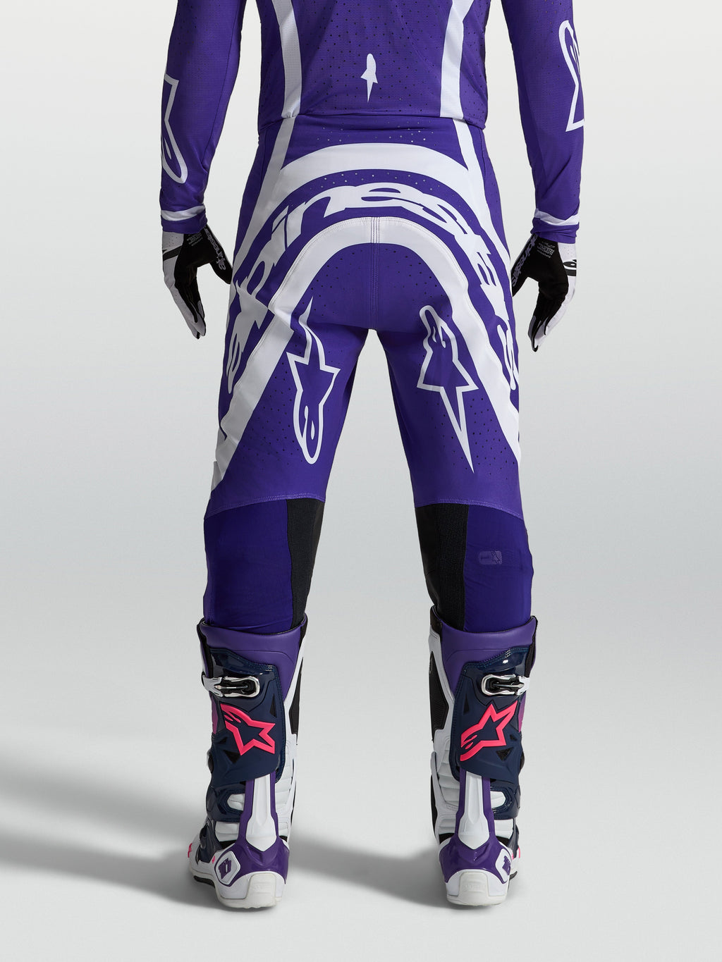 Alpinestars Calças Supertech Vesta, calças de motocross para homem, azul-escuro e branco, vista traseira e tecido rip-stop.