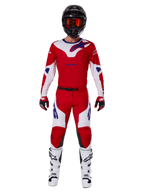 Alpinestars 2025 Racer Veil Pants e conjunto completo de equipamento de motocross, vermelho vivo e branco com detalhes em azul, incluindo camisola a condizer, capacete preto com óculos cor de laranja, botas brancas e pretas e luvas vermelhas, visual de performance coordenado para corridas de todo-o-terreno