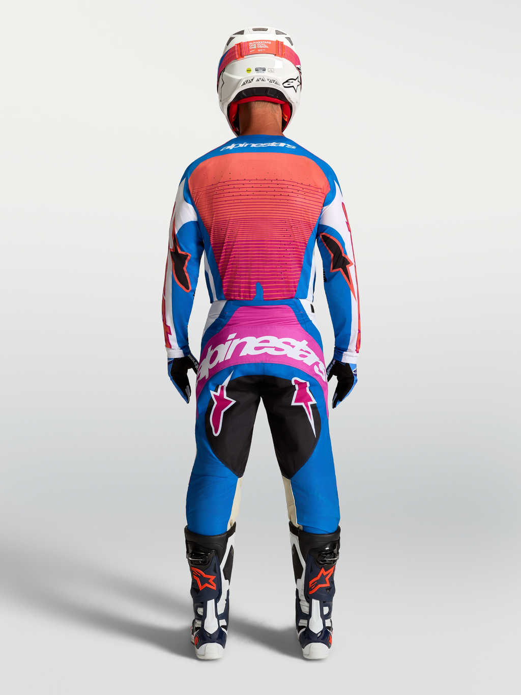 Alpinestars Techstar Maven, calças de motocross para homem, azul e coral, vista traseira com ajuste atlético.