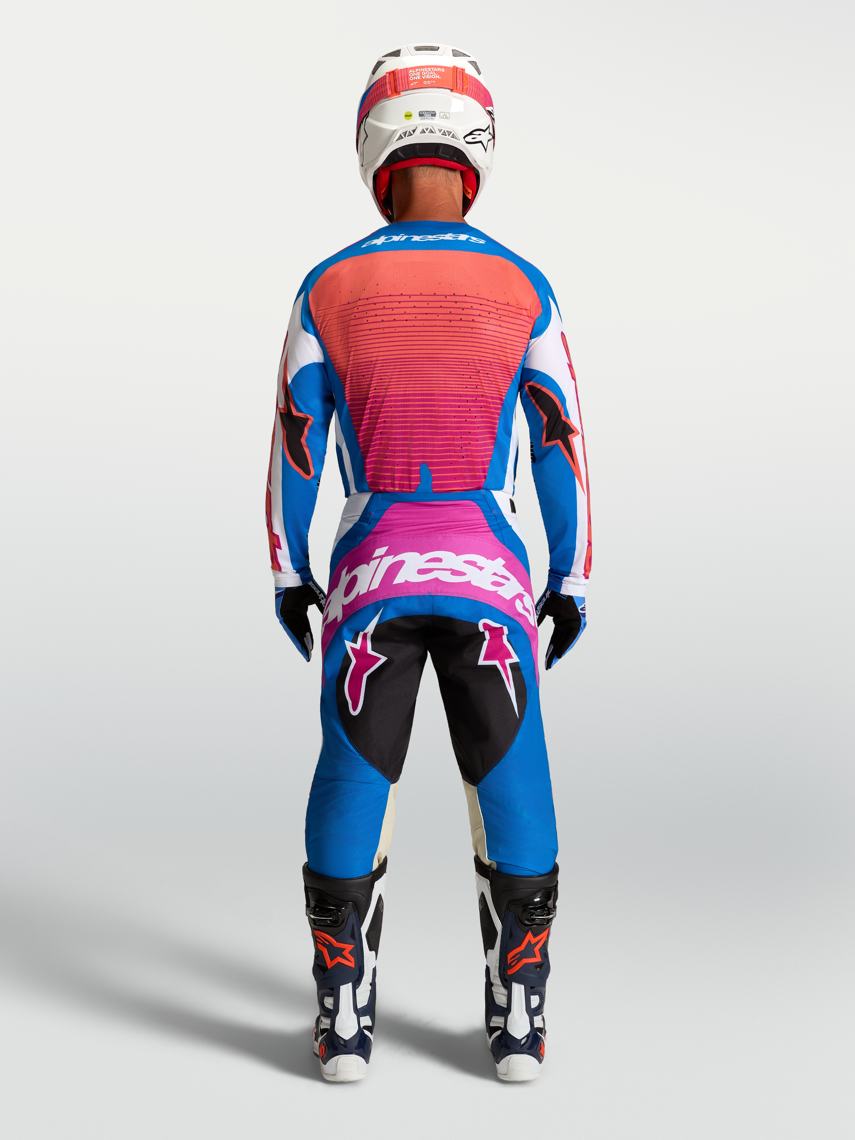 Alpinestars Techstar Maven, calças de motocross para homem, azul e coral, vista traseira com ajuste atlético.