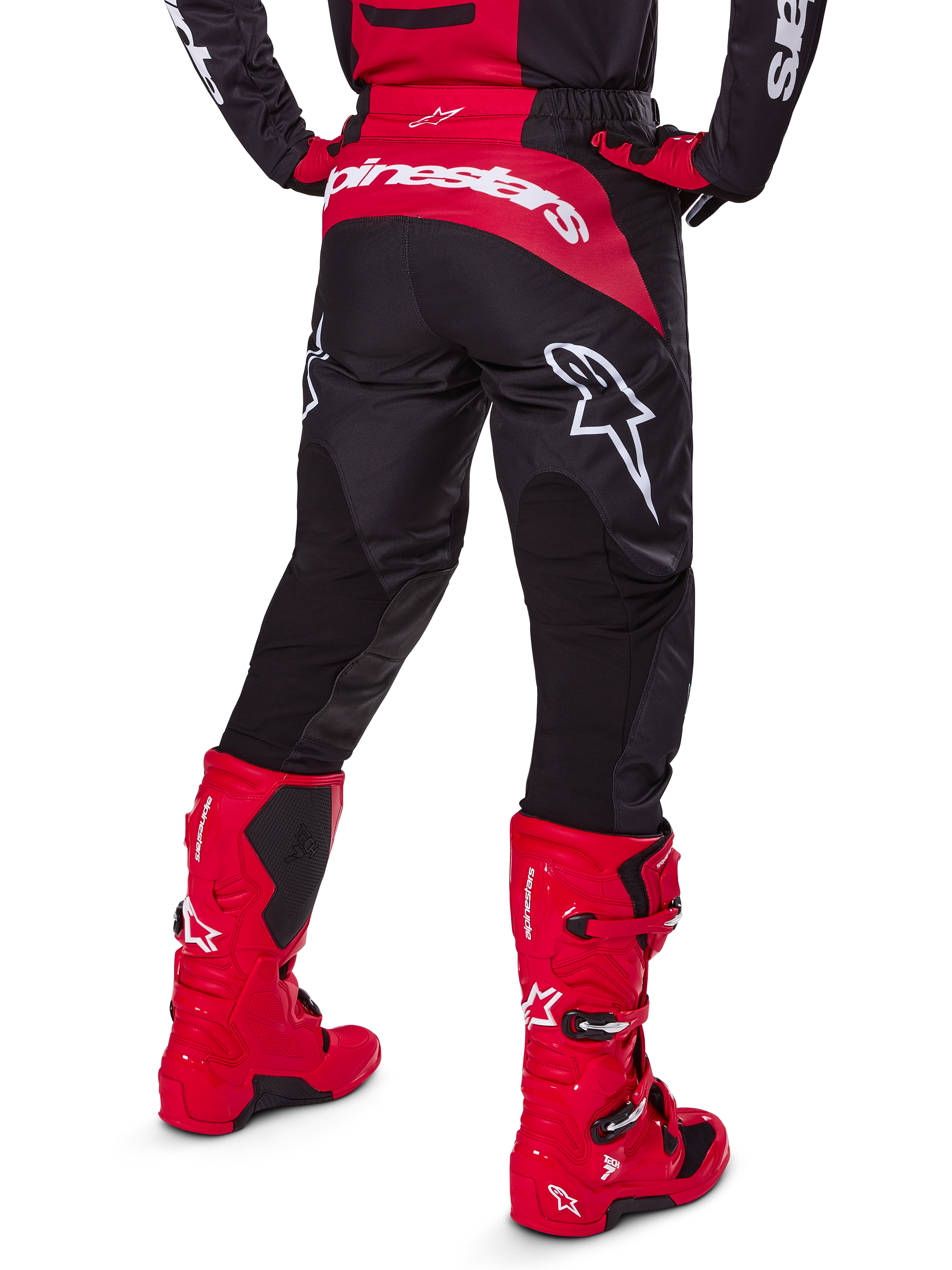 Alpinestars 2025 Fluid Haul Gear Set, Rear View, Black and Red motocross pants with large white logos, matching jersey, and vibrant red Tech 7 boots, coordinated off-road racing kit