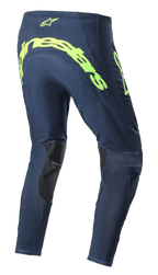 Alpinestars 2023 Supertech Bruin Pants, calças de motocross, azul-escuro e amarelo fluorescente, vista traseira apresentando a marca Alpinestars em amarelo fluorescente de grandes dimensões no assento, zonas de ventilação perfuradas e reforços pretos na parte interna das pernas
