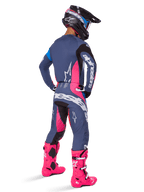 Motocross rider from behind wearing Alpinestars 2025 Techstar Dreem Pants, Gray-blue and Magenta pink design with black accents, worn with a matching jersey and vibrant pink boots, athletic race fit for off-road performance.