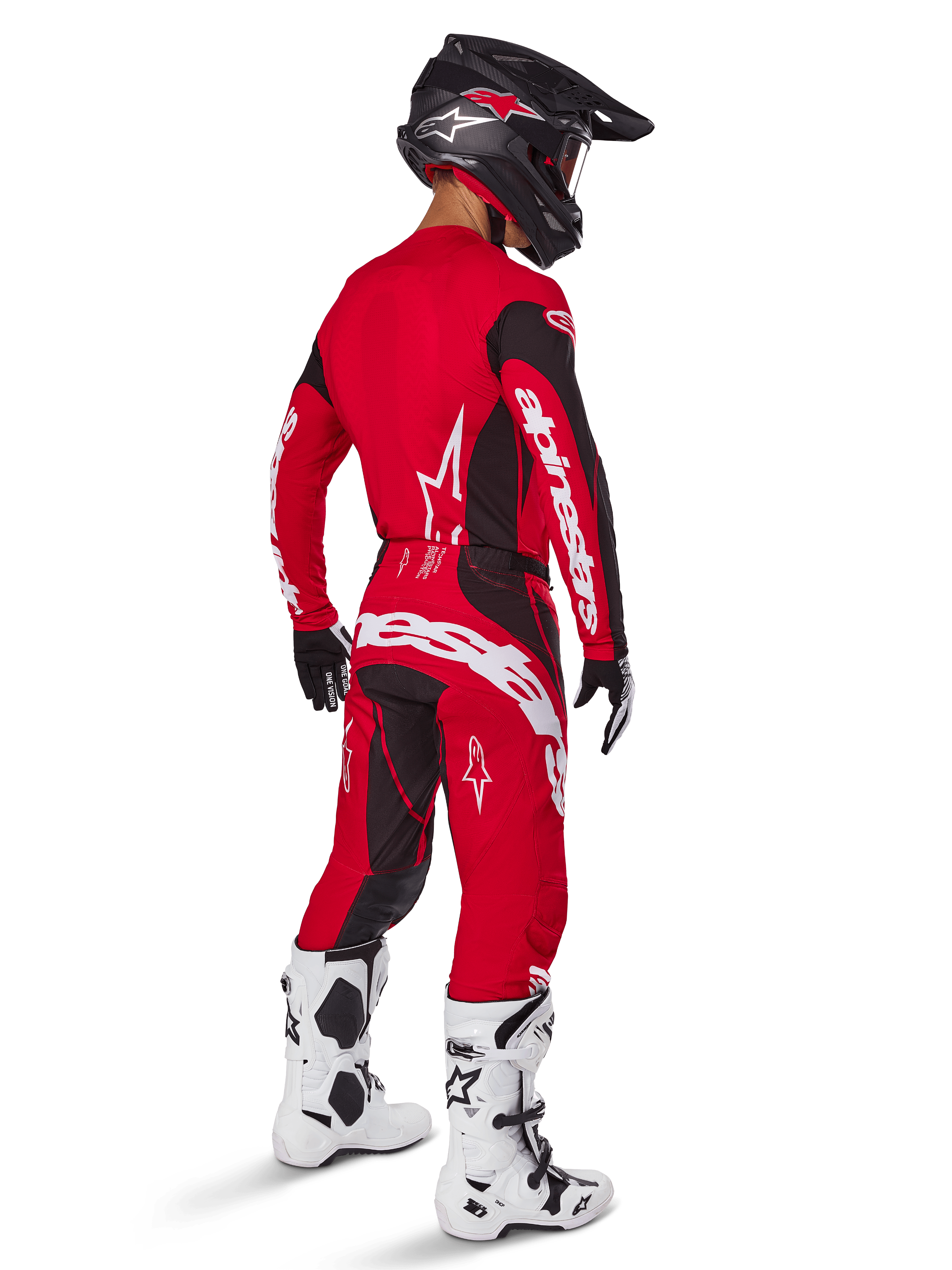 Calças Alpinestars 2025 Techstar Dreem, calças de motocross, vermelho vivo e preto, vistas de uma perspetiva traseira num piloto com equipamento de corrida completo, incluindo camisola vermelha a combinar, capacete preto e botas brancas, com logótipos Alpinestars brancos em destaque e painéis elásticos pretos.