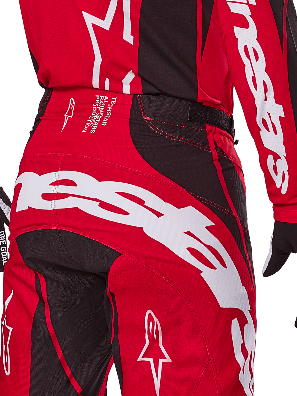 Calças Alpinestars Techstar Dreem 2025, calças de motocross, vermelho vivo e preto, grande plano da zona traseira da cintura e do assento com branding Alpinestars em destaque a branco, painéis elásticos pretos e texto técnico no cós, concebidas para performance em corridas todo-o-terreno.