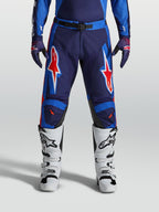 Alpinestars Racer Hunt, calças de motocross para homem, azuis e vermelhas, construção durável pré-curvada com grafismos de estrelas.