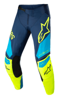 Alpinestars Techstar Factory Pants, calças de motocross, azul escuro, amarelo néon e azul claro, com painéis internos pretos nos joelhos, logótipo de estrela amarela na coxa, marca "ONE GOAL ONE VISION" e zonas de ventilação perfuradas para performance todo-o-terreno