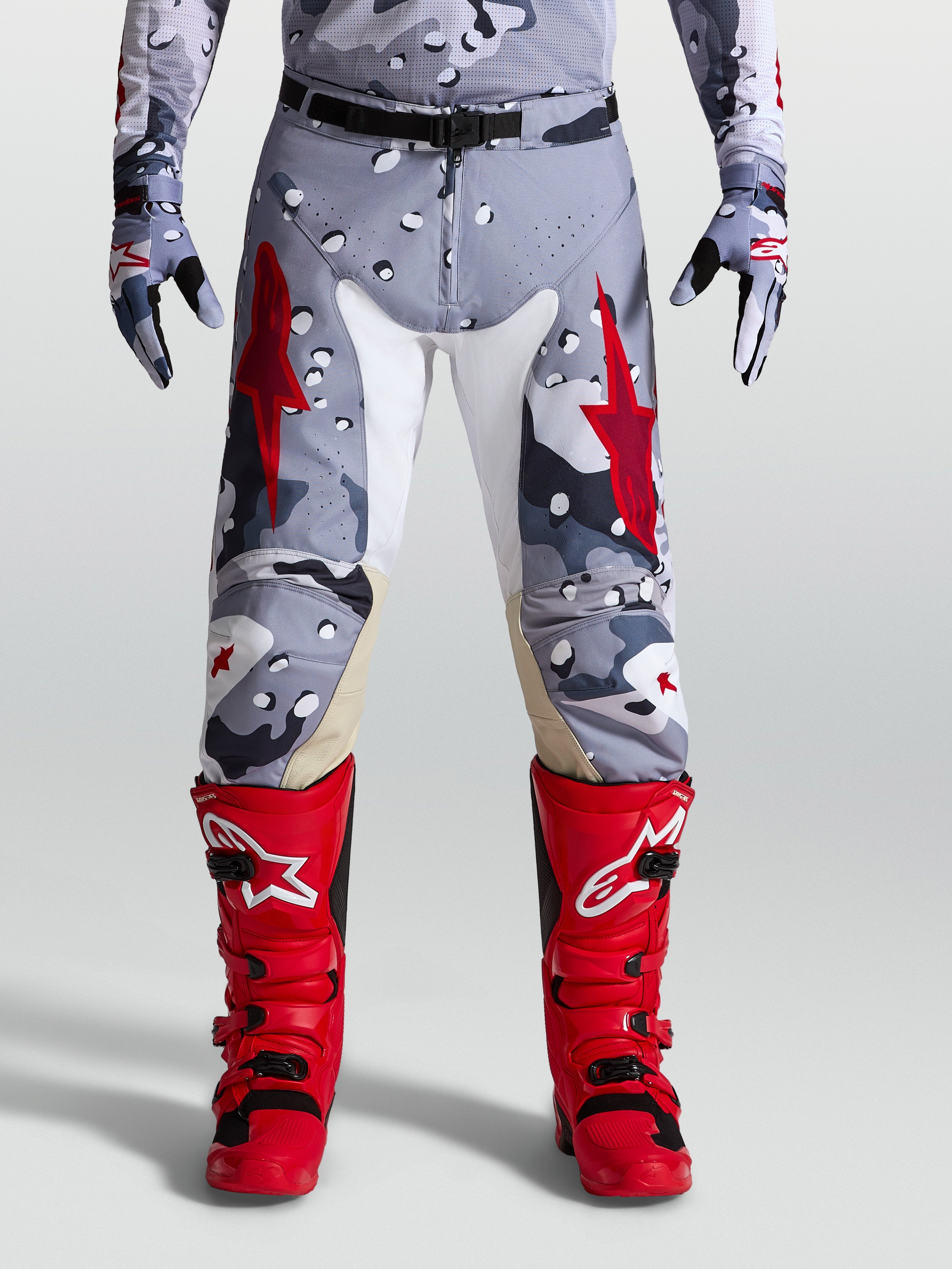 Alpinestars Racer Air Lone Pants, gray camo and fire red motocross gear with perforated fabric and leather inner knees.