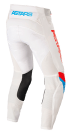 Alpinestars Techstar Quadro Pants, calças de motocross, branco sujo, azul e vermelho vibrante, vista traseira com logótipo 'ASTARS' azul claro na cintura, painéis de ventilação em malha, reforço interior da perna em pele preta e logótipo vermelho na lateral.