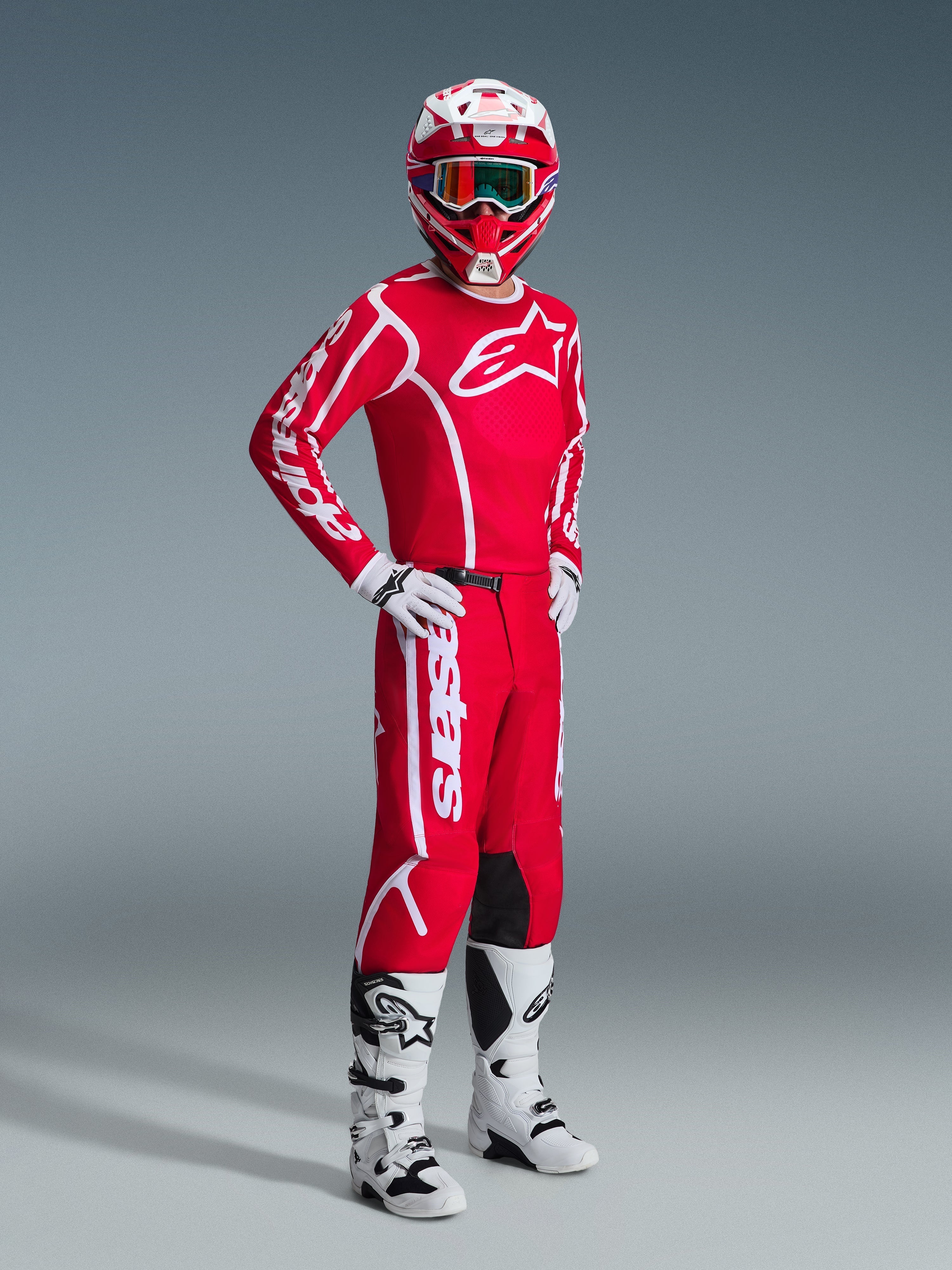 Alpinestars 2026 Fluid Apex Pants, Motocross Pants, Red and White, worn as part of a complete racing gear set with matching jersey, helmet, white boots, and gloves, coordinated outfit for off-road racing