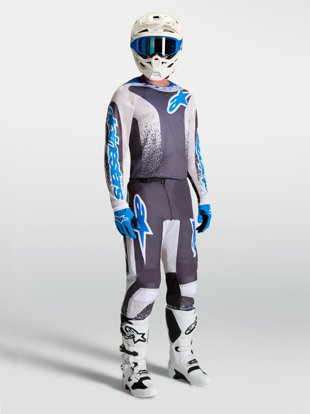 Alpinestars calças Fluid Drag, equipamento de motocross cinzento e azul para homem, com design ergonómico 3D para performance.