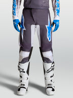 Alpinestars Calças Fluid Drag, calças de motocross para homem, cinzentas e azuis, pernas pré-curvadas e proteção ergonómica.