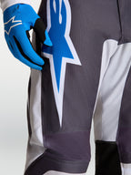 Alpinestars Calças Fluid Drag, calças de motocross para homem, cinzentas e azuis, grafismo de estrela em politecido.