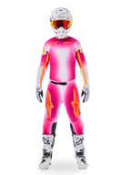 Motocross rider wearing Alpinestars Limited Edition Supertech AFD MIG Gear Set, vibrant Pink Fluo and White gradient jersey and pants with orange logos, white helmet with red goggles, white and black boots and gloves, coordinated professional racing outfit.