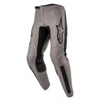 Alpinestars 2024 Fluid Lurv Pants, Motocross Pants, Mud Black, featuring a greyish-tan main chassis with black stretch panels on the inner legs and knees, prominent black Alpinestars logo on the thigh, ergonomic pre-curved design for off-road riding
