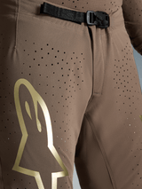 Alpinestars Supertech Air Gold Edição Limitada, calças de motocross castanhas e douradas com fivela SX1 e tecido perfurado.