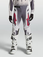 Alpinestars calças Supertech Swan Juventude, calças de motocross, cinzentas e lilás com pormenores vermelhos.
