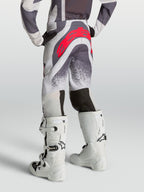 Alpinestars calças Supertech Swan Juventude, calças de motocross cinzentas e lilás com logótipo vermelho, vista traseira.